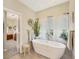 Bathroom with a free-standing tub and natural light from the window at 8012 18Th W Ave, Bradenton, FL 34209
