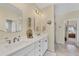 Bathroom featuring double sinks, white cabinetry, and tiled floors at 8012 18Th W Ave, Bradenton, FL 34209