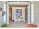 Elegant foyer with tiled floors, colorful artwork, and a glimpse into the home's open and inviting layout at 8012 18Th W Ave, Bradenton, FL 34209