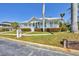 Beautiful home featuring a covered front porch, manicured lawn, and charming curb appeal at 8012 18Th W Ave, Bradenton, FL 34209