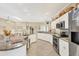 Bright kitchen with white cabinets, stainless appliances, tile floor, and an island counter at 8012 18Th W Ave, Bradenton, FL 34209