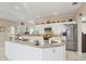 Kitchen featuring a center island, stainless steel refrigerator, and white cabinets at 8012 18Th W Ave, Bradenton, FL 34209