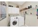 Functional laundry room with washer, dryer, and ample shelving for storage at 8012 18Th W Ave, Bradenton, FL 34209