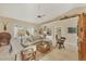 Bright living room with a vaulted ceiling, neutral tones, and access to outdoor views with lots of natural light at 8012 18Th W Ave, Bradenton, FL 34209