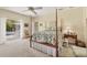 Large primary bedroom featuring a ceiling fan and a view of the screened patio at 8012 18Th W Ave, Bradenton, FL 34209