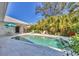 Relaxing pool area with a covered dining space and tropical greenery all around at 8012 18Th W Ave, Bradenton, FL 34209