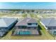 New construction home features a private screened pool and green landscaping at 8046 Anthirium Loop, Sarasota, FL 34240