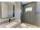 Bathroom featuring granite countertop vanity and shower with dark accents at 8046 Anthirium Loop, Sarasota, FL 34240