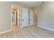 Neutral bedroom has wood-look tile floors and white doors and trim at 8046 Anthirium Loop, Sarasota, FL 34240