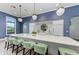 Large community kitchen features island with seating and modern pendant lighting at 8046 Anthirium Loop, Sarasota, FL 34240