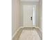 Bright foyer featuring wood-look tile flooring and a contemporary front door with sidelight at 8046 Anthirium Loop, Sarasota, FL 34240