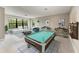 Game room featuring large windows, pool table, and plenty of seating at 8046 Anthirium Loop, Sarasota, FL 34240