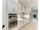Well-equipped kitchen featuring stainless steel appliances, white cabinets, and a gas range at 8046 Anthirium Loop, Sarasota, FL 34240