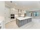 Bright, modern kitchen featuring a large island, stainless steel appliances, and stylish gray and white cabinetry at 8046 Anthirium Loop, Sarasota, FL 34240