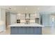 Elegant kitchen with white cabinets, stainless steel appliances, a large island, and access to the staircase at 8046 Anthirium Loop, Sarasota, FL 34240