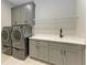 Modern laundry room with appliances, ample counter space, and custom cabinetry at 8046 Anthirium Loop, Sarasota, FL 34240
