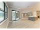 Open concept living area with tile floors, slider doors to the lanai, and a kitchen island at 8046 Anthirium Loop, Sarasota, FL 34240