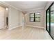 Bright, spacious living area featuring neutral tones, tile flooring, and sliding doors to the lanai at 8046 Anthirium Loop, Sarasota, FL 34240