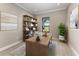 Home office with wood desk, shelving, and a window providing natural light at 8046 Anthirium Loop, Sarasota, FL 34240