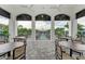 Covered outdoor seating area overlooking the pool, with tables and chairs for relaxing at 8046 Anthirium Loop, Sarasota, FL 34240