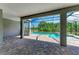 An empty outdoor patio offers a spacious view of the pool and backyard landscaping at 8046 Anthirium Loop, Sarasota, FL 34240