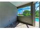 A covered patio with a window overlooking the yard at 8046 Anthirium Loop, Sarasota, FL 34240