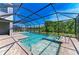 A screened-in pool and spa offer a refreshing escape in this backyard oasis at 8046 Anthirium Loop, Sarasota, FL 34240