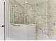 Luxurious glass shower with marble tile and modern fixtures at 8046 Anthirium Loop, Sarasota, FL 34240
