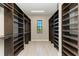 Spacious walk-in closet with custom shelving and a window for natural light at 8046 Anthirium Loop, Sarasota, FL 34240