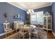 Charming dining room features blue walls, white furnishings, and a bright window at 8140 Gabanna Dr, Sarasota, FL 34231