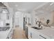 Modern kitchen featuring white cabinets, stainless appliances, large island, and open layout at 8330 Abingdon Ct, University Park, FL 34201