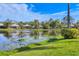 Picturesque view of the community pond reflecting nearby homes and lush landscaping at 8330 Abingdon Ct, University Park, FL 34201