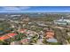 Neighborhood aerial view of a home with a screened in pool nestled among lush landscaping at 8420 Sailing Loop, Lakewood Ranch, FL 34202