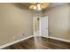 Bedroom with hardwood floors, ceiling fan, and closet at 8420 Sailing Loop, Lakewood Ranch, FL 34202