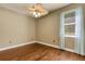 Bedroom with hardwood floors, ceiling fan, and window with curtains at 8420 Sailing Loop, Lakewood Ranch, FL 34202