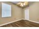 Bedroom showcasing hardwood floors, ceiling fan, and a window with blinds at 8420 Sailing Loop, Lakewood Ranch, FL 34202