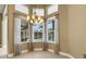 Bright dining area featuring large windows, tile floors and a chandelier at 8420 Sailing Loop, Lakewood Ranch, FL 34202