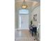 Entrance foyer featuring an arched entryway, mosaic tile, and transom window above front door at 8420 Sailing Loop, Lakewood Ranch, FL 34202