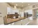 Bright kitchen featuring granite countertops, white cabinetry, and stainless steel appliances at 8420 Sailing Loop, Lakewood Ranch, FL 34202