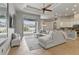 Open-concept living room leading to a pool area with large sectional sofa and tile flooring at 8420 Sailing Loop, Lakewood Ranch, FL 34202