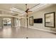 Spacious living room featuring tile flooring, large windows, and neutral color palette throughout at 8420 Sailing Loop, Lakewood Ranch, FL 34202