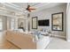 Inviting living room with ceiling fan, two large mirrors, and comfortable sectional sofa at 8420 Sailing Loop, Lakewood Ranch, FL 34202