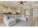 Spacious open-concept living room with tile floors seamlessly integrates living, dining, and kitchen at 8420 Sailing Loop, Lakewood Ranch, FL 34202