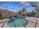 Backyard screened pool featuring a spa and lush landscaping around the property at 8420 Sailing Loop, Lakewood Ranch, FL 34202
