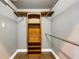 Organized walk-in closet with wooden shelves, drawers, and chrome rods, perfect for storage at 8420 Sailing Loop, Lakewood Ranch, FL 34202