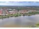 Expansive aerial view of a neighborhood of homes with lakes and ponds, surrounded by lush greenery and scenic landscapes at 854 Dahoon Cir, Venice, FL 34293