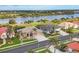Beautiful aerial view of a home in a waterfront community with lush greenery and scenic views of a lake at 854 Dahoon Cir, Venice, FL 34293