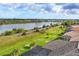 Picture perfect backyard view of lush green grass leading to a peaceful body of water at 854 Dahoon Cir, Venice, FL 34293