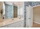 Bathroom featuring blue floral wallpaper, updated shower and fixtures, and a white vanity with storage at 854 Dahoon Cir, Venice, FL 34293