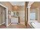 Bathroom offers a walk-in shower and a soaking tub, along with a beautiful wallpaper at 854 Dahoon Cir, Venice, FL 34293